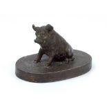 A patinated metal seated pig on oval base, unmarked, 5.5 x 8.3cm.Additional InformationSome