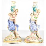 A large pair of late 19th century Continental porcelain figural candlesticks on shaped bases, both