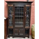 An Arts and Crafts oak cabinet (possibly Scottish), with two lead glazed doors, each with Arts and