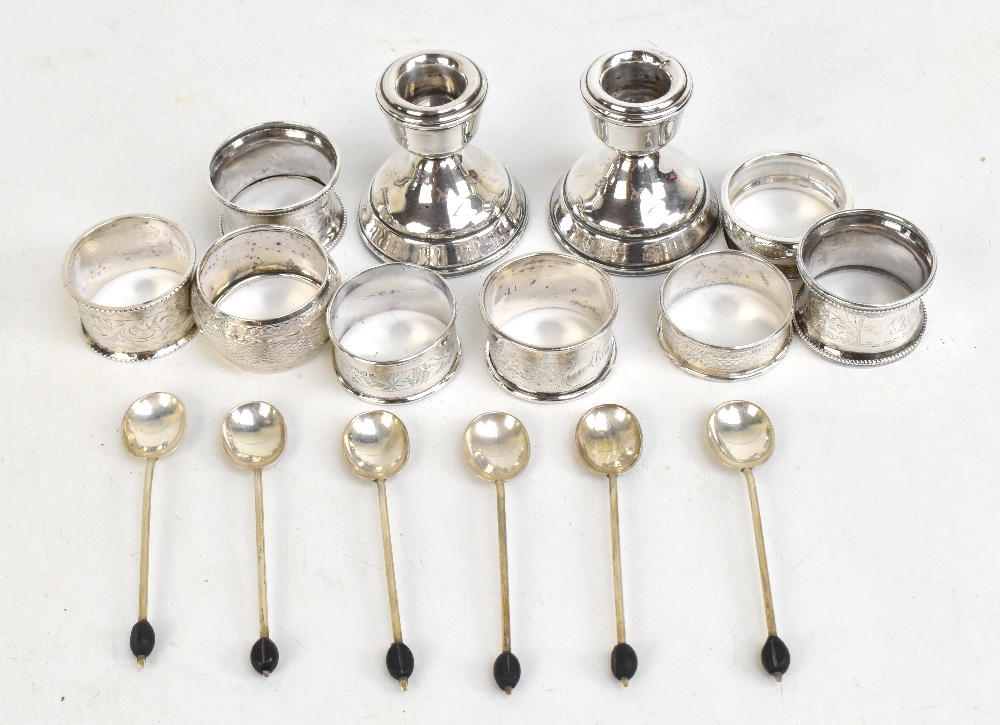 Eight various hallmarked silver napkin rings, a set of six hallmarked silver coffee spoons with bean