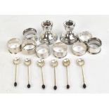 Eight various hallmarked silver napkin rings, a set of six hallmarked silver coffee spoons with bean