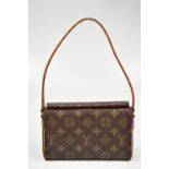 LOUIS VUITTON; a brown coated canvas monogram Pochette, with leather shoulder strap and red suede