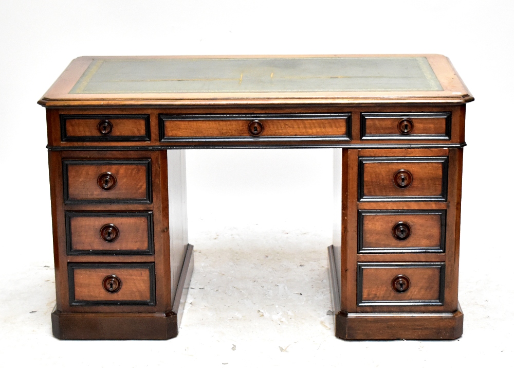 A 19th century French walnut kneehole desk with an arrangement of nine drawers and single locking