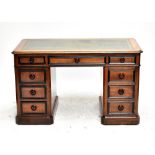 A 19th century French walnut kneehole desk with an arrangement of nine drawers and single locking