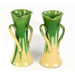 ALLER VALE; a pair of green and cream glazed vases with twisted handles, both with impressed