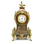 A 19th century boullework mantel clock, with mythical beast finial and inlaid brass scrolling