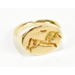 A 14ct yellow gold ring in the Minoan style, incised decorated with a horse to the oval platform,