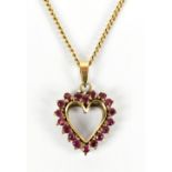 A 9ct yellow gold heart pendant set with red stones, length excluding bale 1.9cm, on 9ct curb link