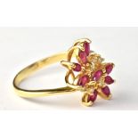 A yellow metal floral motif dress ring set with pink and white coloured stones, stamped '18K 750' to