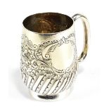 An Edward VII hallmarked silver christening cup with foliate scroll detail, twin vacant cartouches