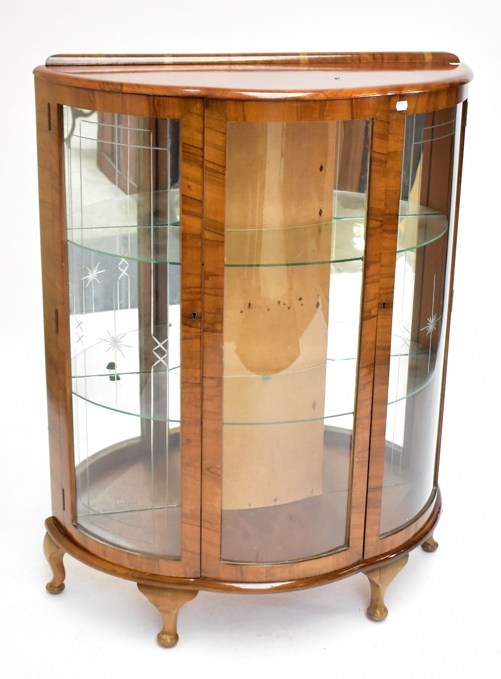 An early 20th century Art Deco burr walnut veneered display cabinet of shaped outline with twin