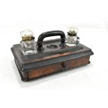 A Victorian walnut and ebonised ink stand dish with twin square sectioned glass wells central