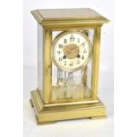 A late 19th century French brass cased mantel clock, the circular dial set with Arabic numerals,
