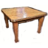 An Arts and Crafts oak extending dining table, with one extra leaf raised on tapering support.