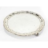 WILLIAM HUTTON & SONS; a George V hallmarked silver card tray with scalloped edge, raised on three