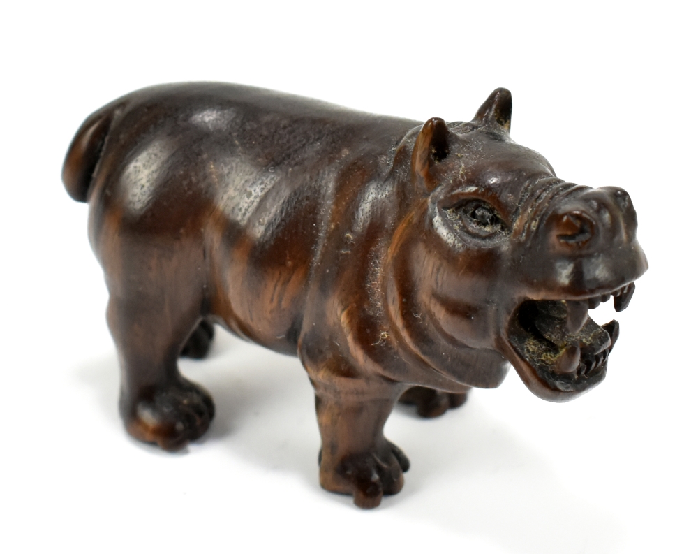 A Japanese carved hardwood netsuke modelled as a hippo, with twin character mark, length 5.5cm.
