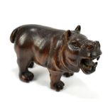 A Japanese carved hardwood netsuke modelled as a hippo, with twin character mark, length 5.5cm.
