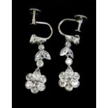 A pair of white metal and diamond floral drop earrings, with screw backs, approx 3.2g.Additional