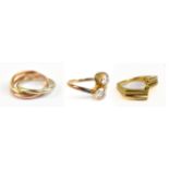 A 9ct yellow gold shaped ring, size K, a 9ct gold triple link ring, and a 9ct two stone crossover