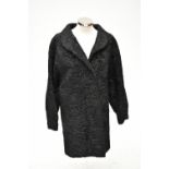 FUR COAT; a 1950s short length Astrakhan/Persian lamb coat.Additional InformationGeneral wear, but