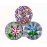 JOHN DEACONS; two glass paperweights, each internally decorated with floral sprays, one signed and