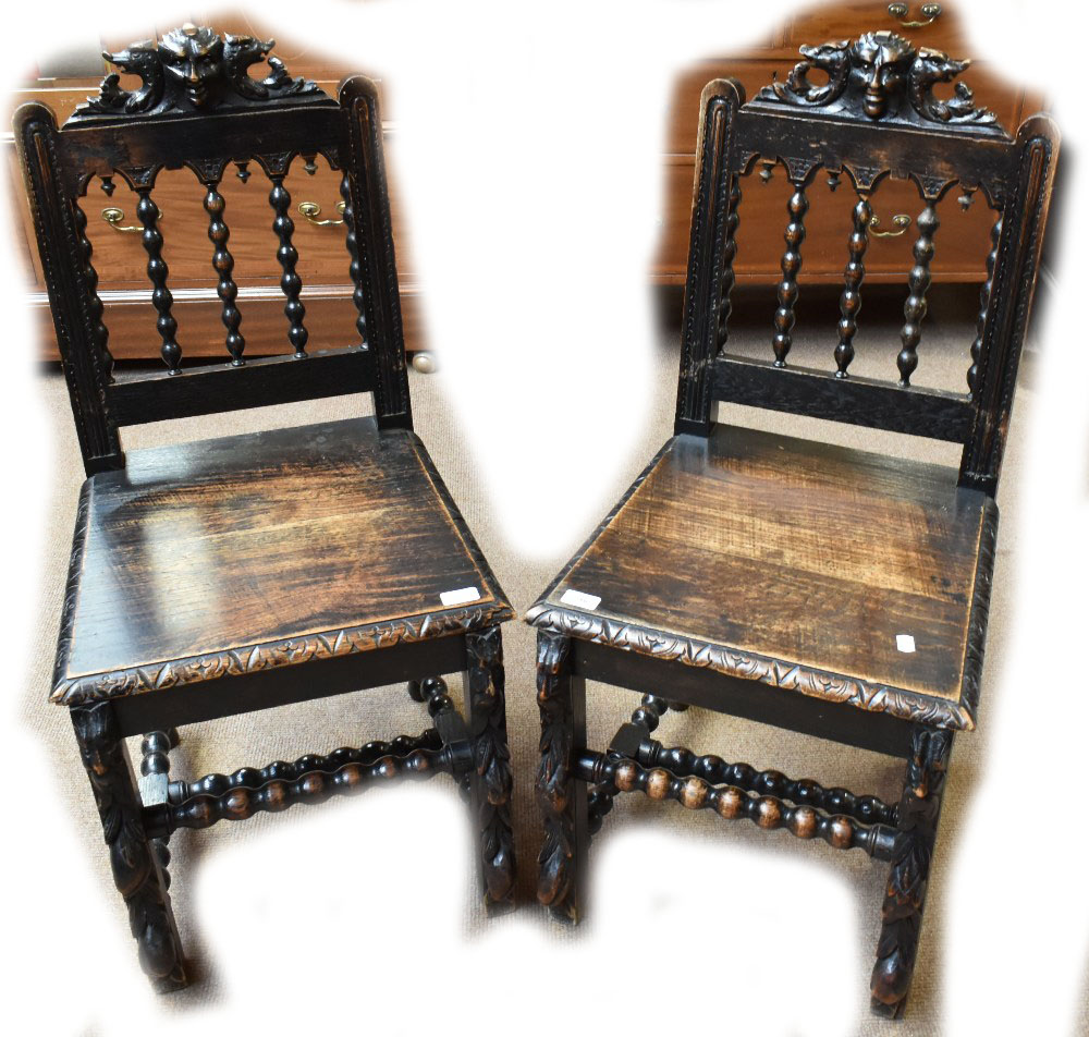 A pair of late Victorian carved oak hall chairs (2).Additional InformationEach seat worn through