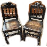 A pair of late Victorian carved oak hall chairs (2).Additional InformationEach seat worn through