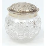 WILLIAM COMYNS; an Edward VII hallmarked silver lidded clear hobnail cut glass vanity jar, the lid