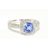 An 18ct white gold tanzanite and diamond ring, with diamonds set to the shank and also inner and