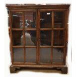 An oak glazed two door display cabinet raised on bracket feet, width 98cm.Additional