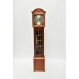 A reproduction grandmother clock.