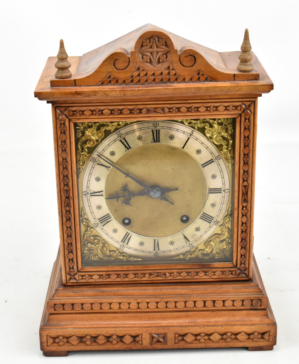 WINTERHALDER & HOFMEIER; a circa 1900 German walnut mantel clock with carved detail, the silvered
