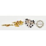 Four brooches comprising an 18ct yellow gold ruby set example, approx 5.1g, also a 9ct yellow gold