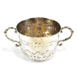 A James II hallmarked silver twin handled porringer, with scrolling handles, upper band of