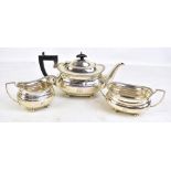 ADIE BROS LTD; a George V hallmarked silver three piece tea set with gadrooned detail, all