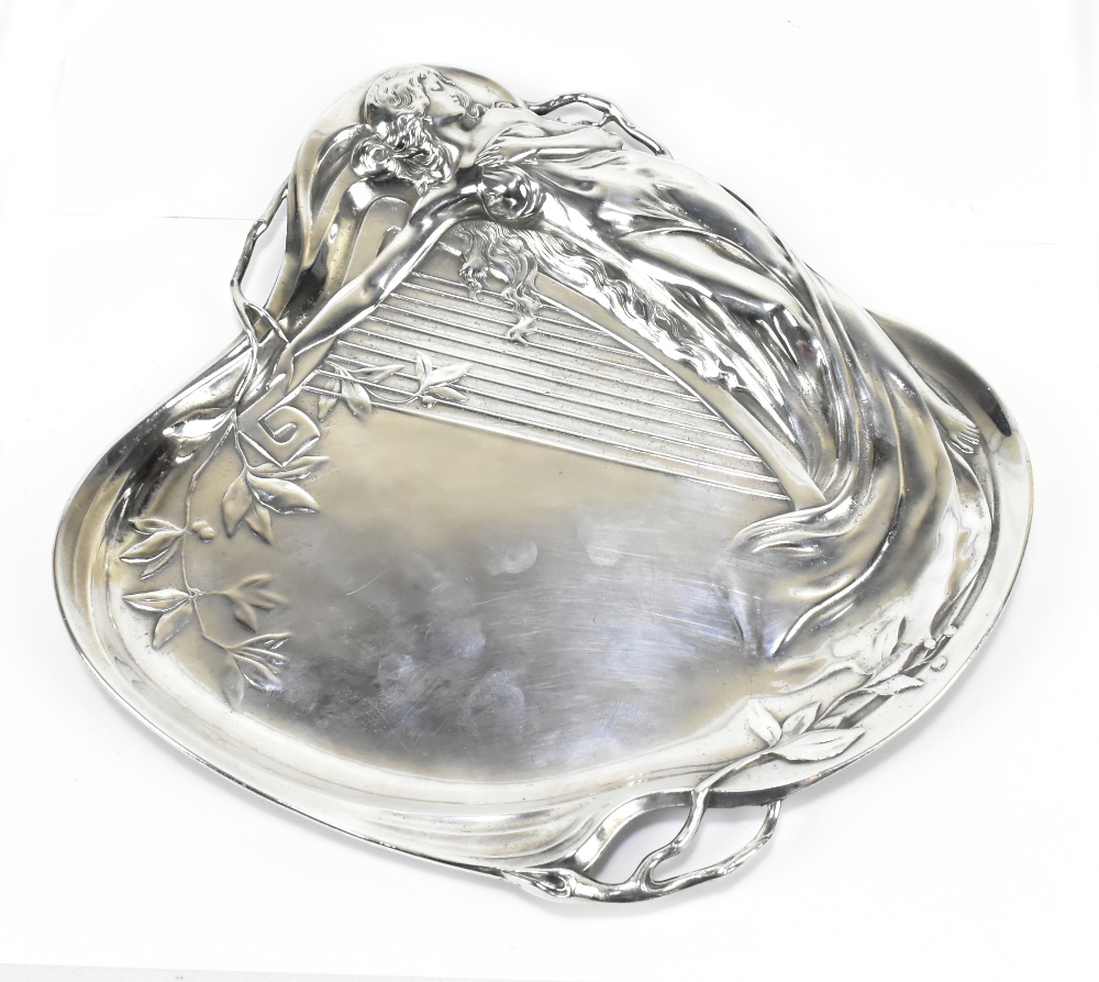 WMF; an Art Nouveau electroplated tray of shaped outline, featuring lady and harp in relief, stamped