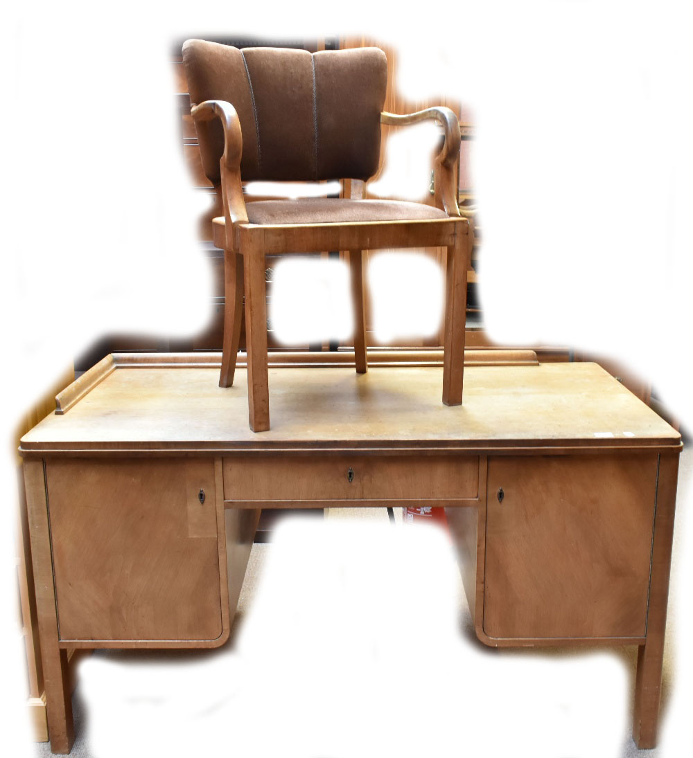 An early 20th century German walnut desk, with single drawer flanked by two cupboard doors, size 145