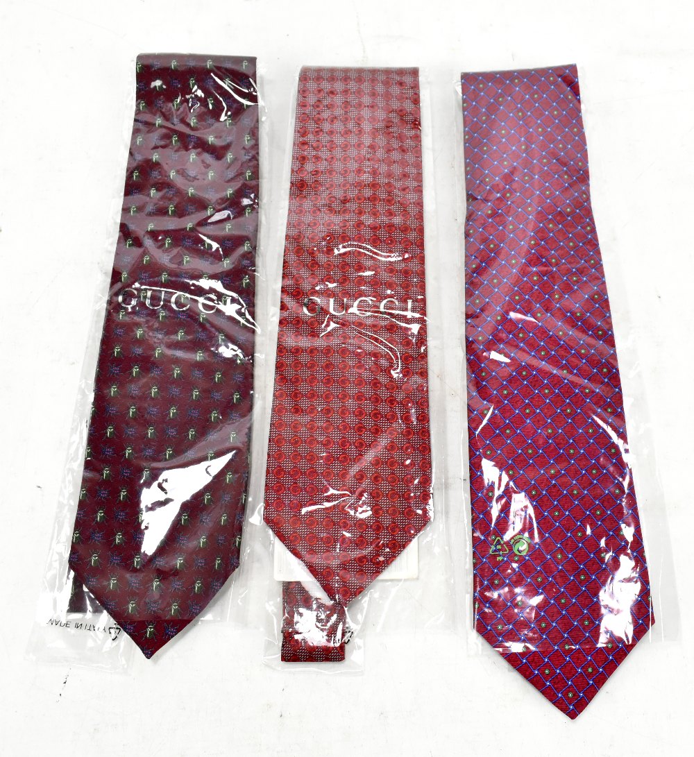 BVLGARI; a red, blue and green chequered silk tie, a Gucci red silk tie with GG logo crest, and a