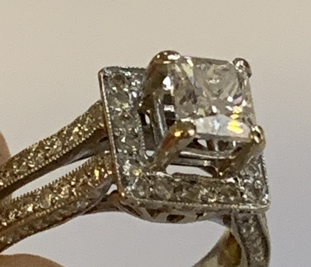 An 18ct white gold and diamond ring, the raised central princess cut stone within a border of twenty - Image 4 of 4