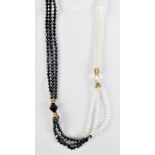A vintage multi strand glass black and clear beaded necklace, with yellow metal spaces, length