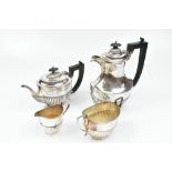 JAMES DEAKIN & SONS; a George V hallmarked silver four piece tea service of part gadrooned oval