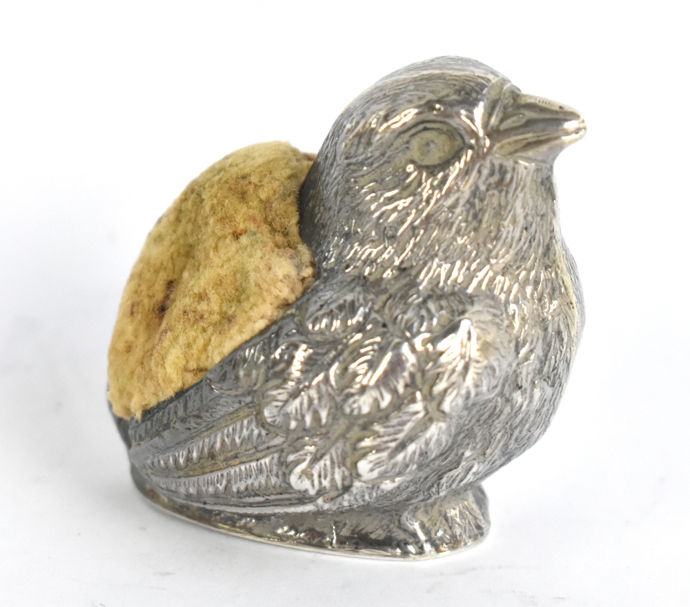 A late Victorian hallmarked silver pin cushion modelled as a chick, maker's and date marks obscured,