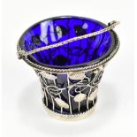 DAVID BELL; a George III hallmarked silver swing handled basket with blue glass liner and pierced