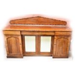 A 19th century mahogany sideboard with arched back, frieze drawers and breakfront central section,