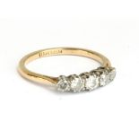 An 18ct yellow gold and platinum ring set with five diamond of graduated size, approx 2.7g.