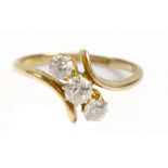 An 18ct yellow gold three stone diamond ring, the central stone weighing approx 0.20ct with 0.10ct