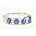 An 18ct white gold sapphire and diamond ring with four oval sapphires totalling approx 1ct and ten