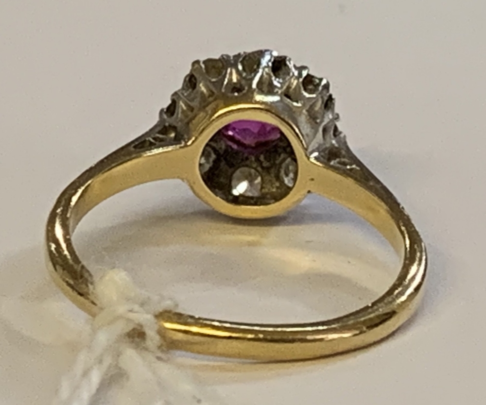 An 18ct yellow gold diamond and ruby cluster ring, the ruby weighing approx 0.25ct within a border - Image 2 of 4