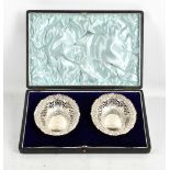 FLORENCE WARDEN; a cased pair of Victorian hallmarked silver pierced bonbon dishes with repousse