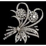 An impressive platinum and diamond floral spray brooch with two principal cluster heads set on